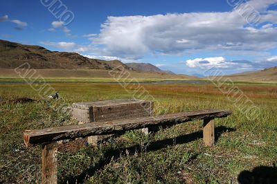 alone bench in the mountain valey