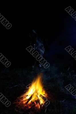 Person sitting near of a fire