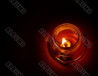 Candle in darkness