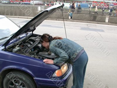 girl repairs car