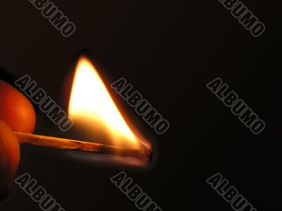 Fired match in hand