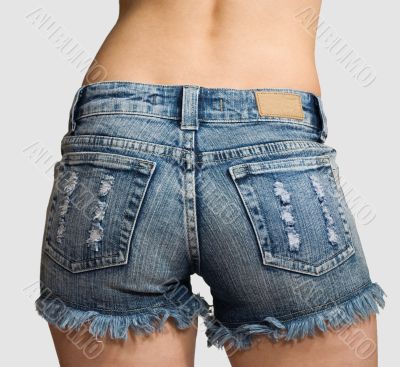 Girl in blue jeans short shorts isolated