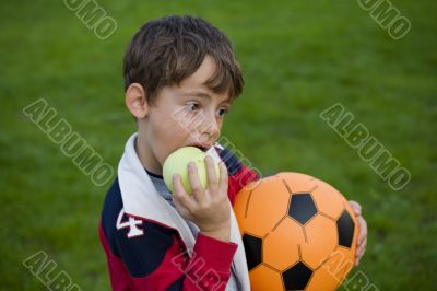 Boy with apple and ball