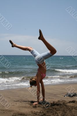 girl, a gymnastics at the seashore