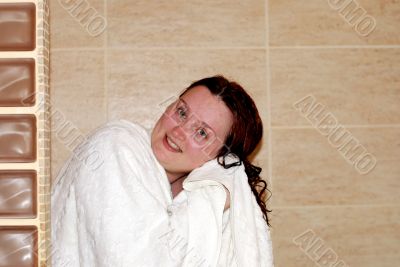The woman in a bath wipes hair