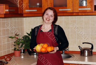 The young red woman on kitchen