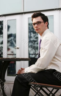 Businessman sitting outside at a table