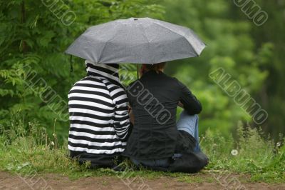 Girlfriends under a umbrella