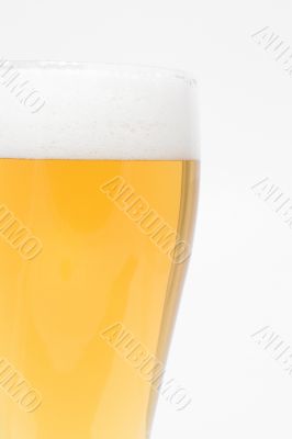 A pilsner glass of ice cold beer.