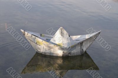 a paper boat floating in a lake