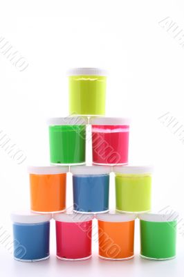 stack of colorful paints close-ups isolated