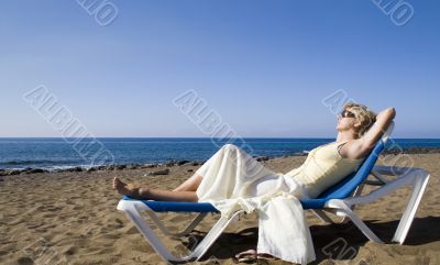 a woman resting on the beach