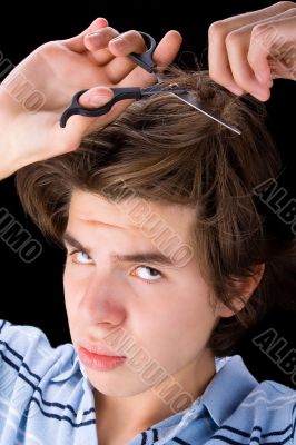Boy cutting his hair 2