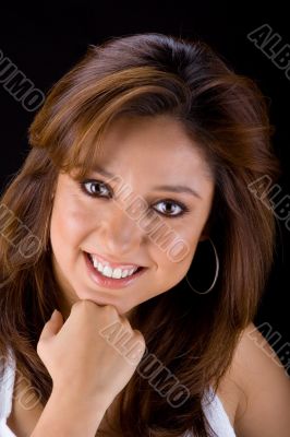 Brunette smiling with fist on chin