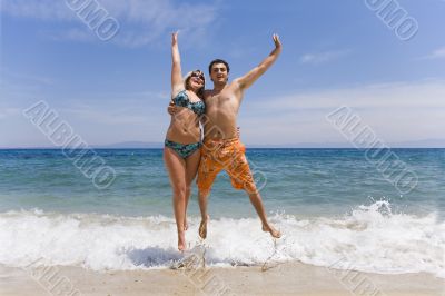 Young men jump on seacoast