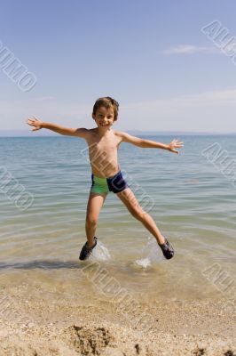Child jump on seacoast
