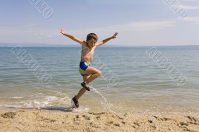 Child jump on seacoast