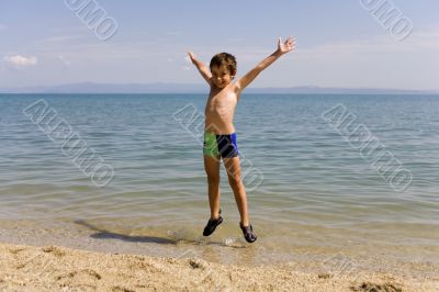 Child jump on seacoast