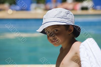 portrait of the boy beside swimming pool