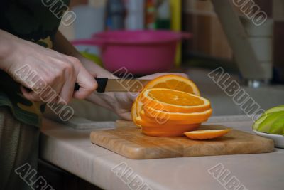 Knife cutting vegetables on kitchen table.