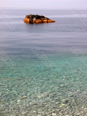 Stone in transparent clear water