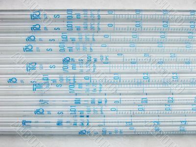 Glass pipettes on white background