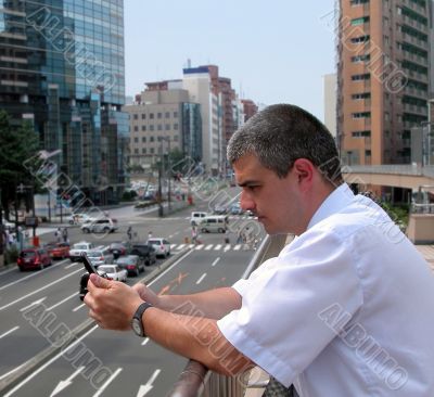 Man with mobile phone in a city
