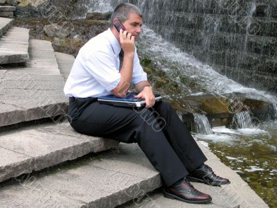 Man with phone and computer
