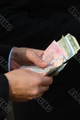 Male hands counting different money banknotes
