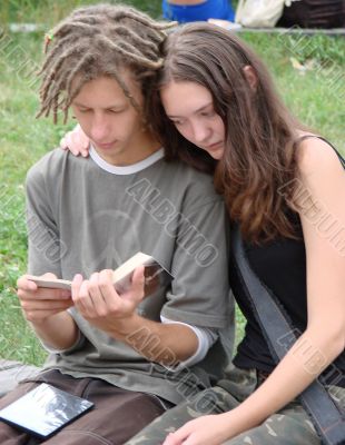 Young stydents reading in street