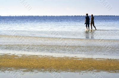 The people go for a walk on the sea
