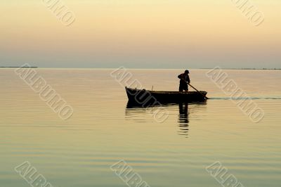 Lonely boat and beautiful sunrise