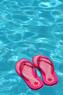 Sandals by a swimming pool