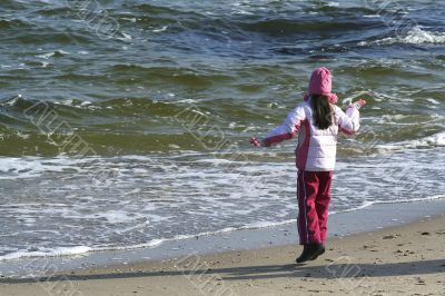 The girl plays with a wave