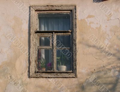 Alone window of aged ruined urban building