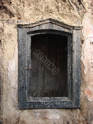 Alone window of aged ruined urban building