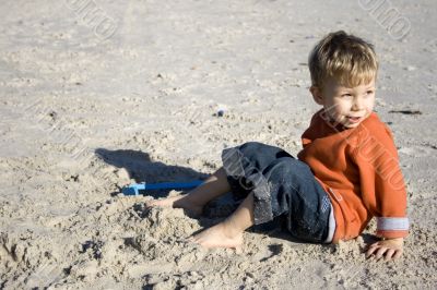 Boy sitting on the sand