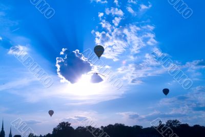 three ballon on cloudy sky
