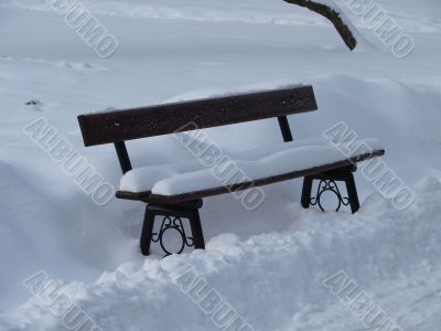 Snowy winter town square bench