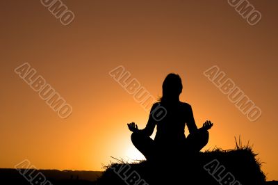Woman silhouette making yoga
