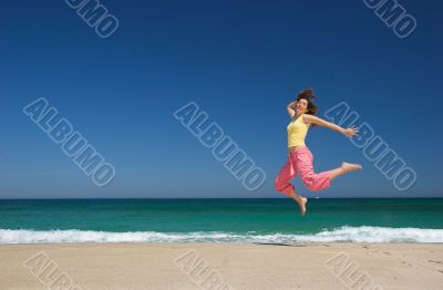 beautiful woman jumping in the beach