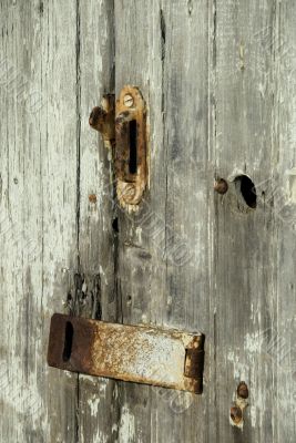Old barn door with rusty latch