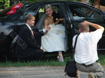 Wedding photographer with bride and groom