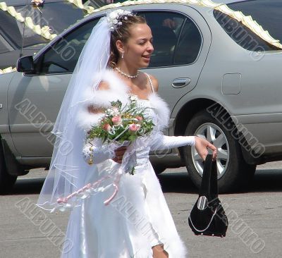 Young bride running on wedding day