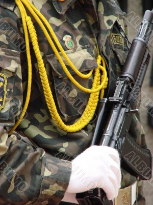 one uniformed weaponed soldier in parade