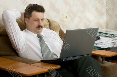 Young the man working on notebook at home