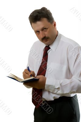 Young man writing down the information