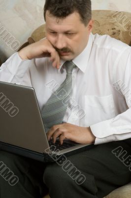 Young the man working on notebook at home
