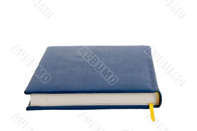 Dark blue notebook on a table. Close up.