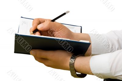 Hand writing to a notebook. Close up.